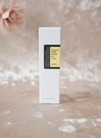 Envase de COSRX Advanced Snail Peptide Eye Cream de K-Chic Skin Especialidad sobre fondo suave y elegante